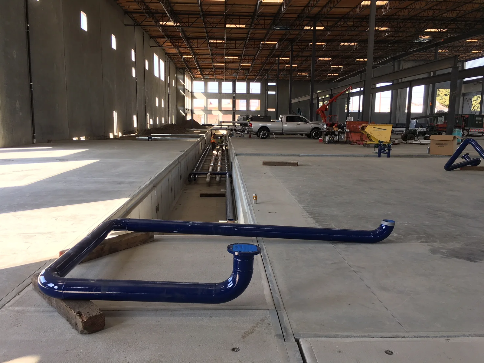 Industrial utility piping installed in a recessed service trench
