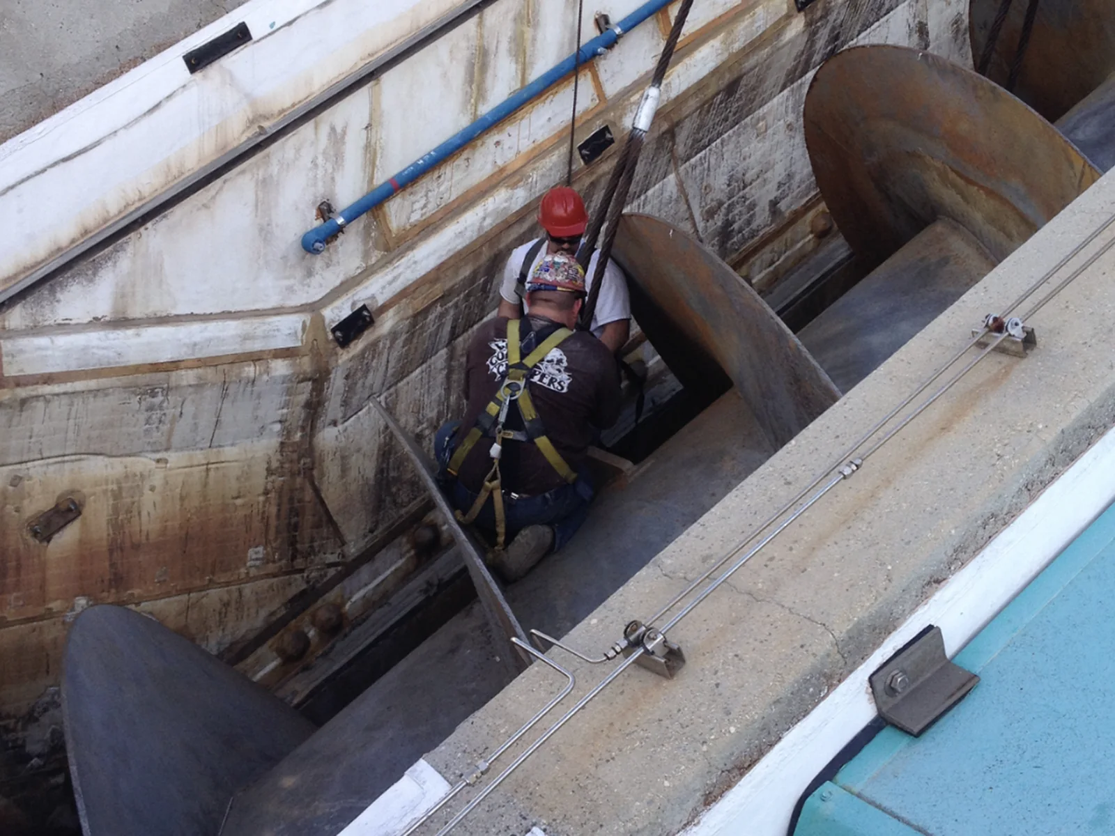 URE crew removing an industrial auger from a concrete process chamber