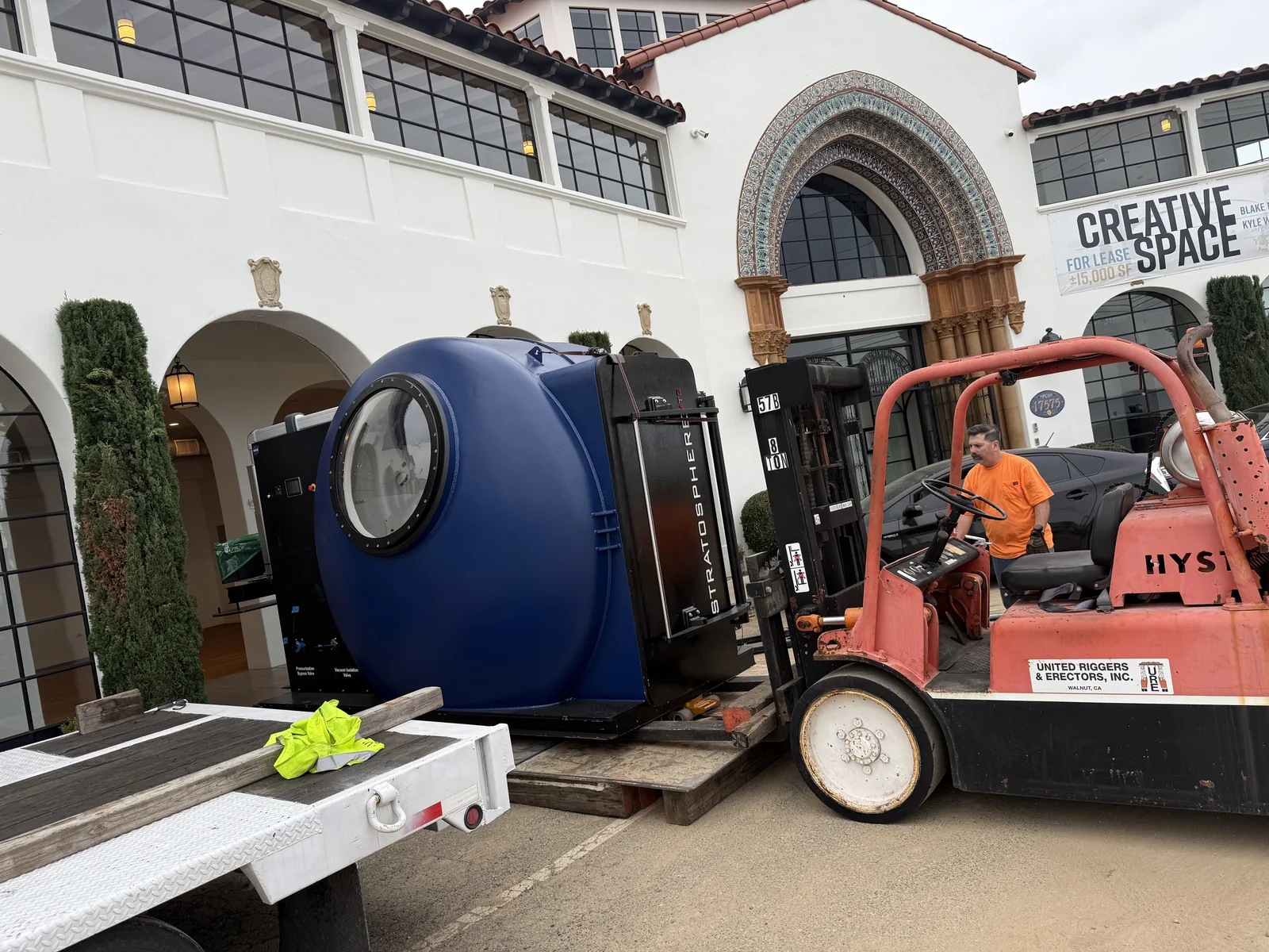 URE crew guiding a vacuum chamber during an industrial equipment move
