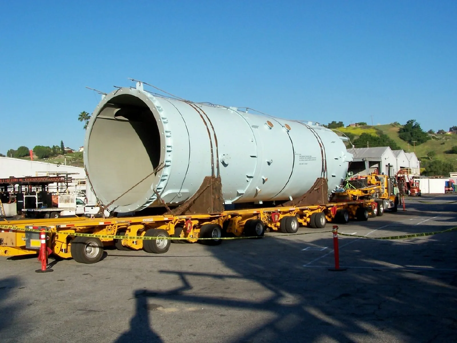 Oversize cylindrical vessel loaded on a multi-axle transport trailer