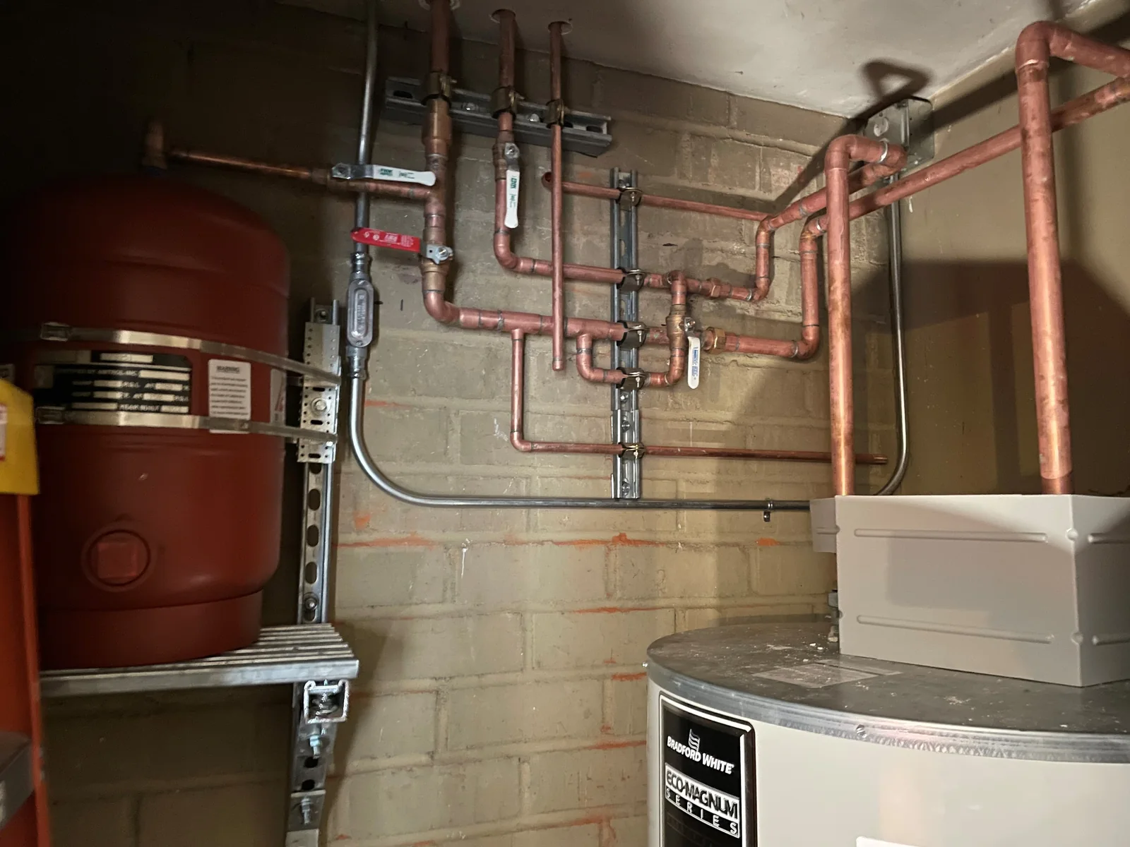 Copper piping and valves connected to industrial water-heating equipment